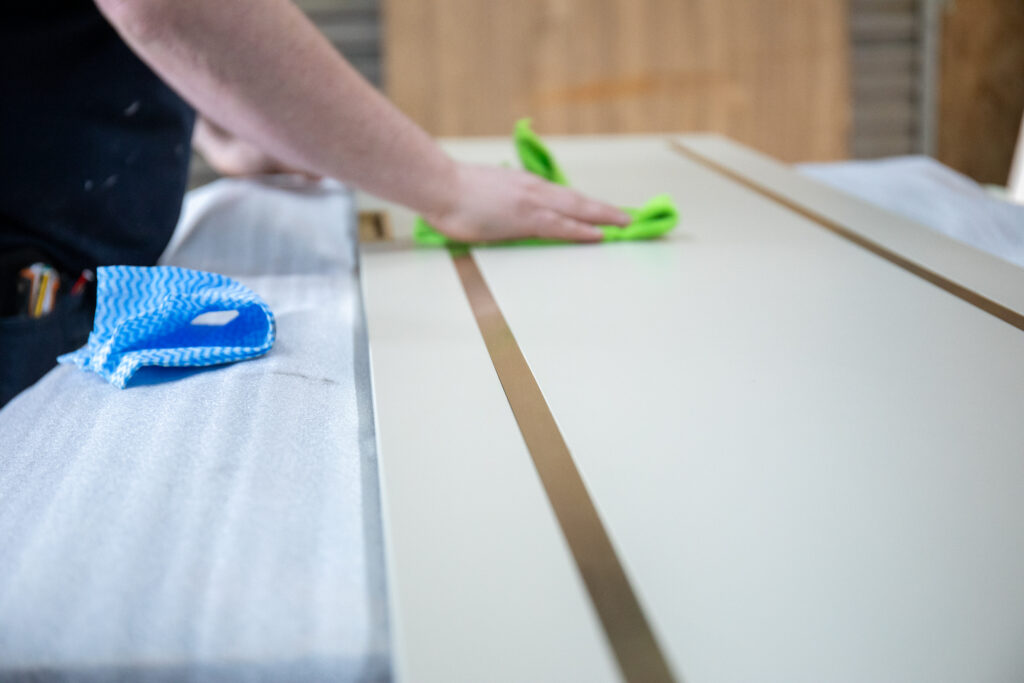 Shot of gold lined kitchen door panel being polished